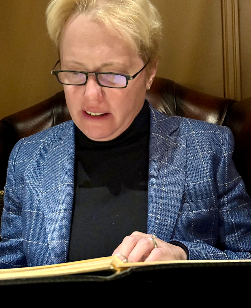 Monica Berlin reviewing a binder