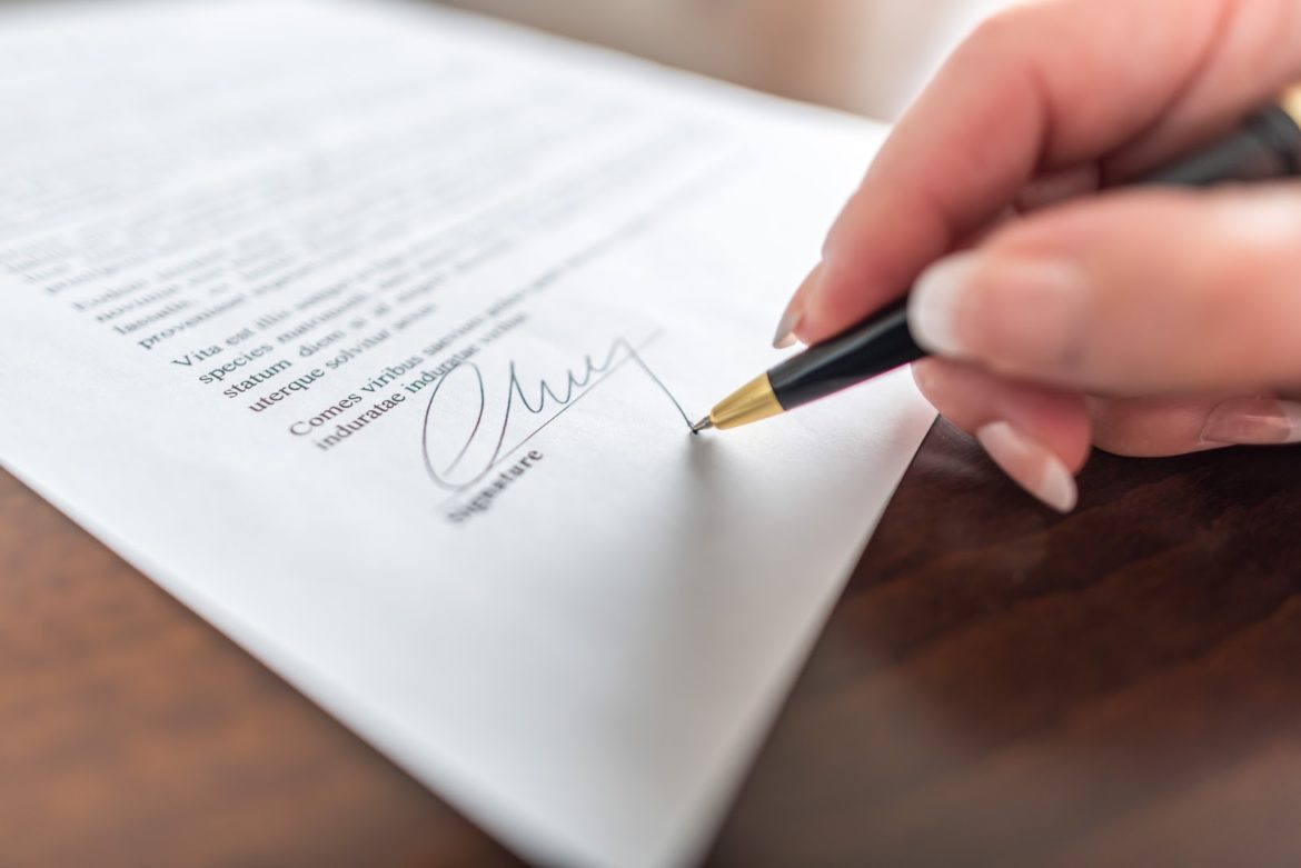 Patient reviewing and signing a surgical consent form